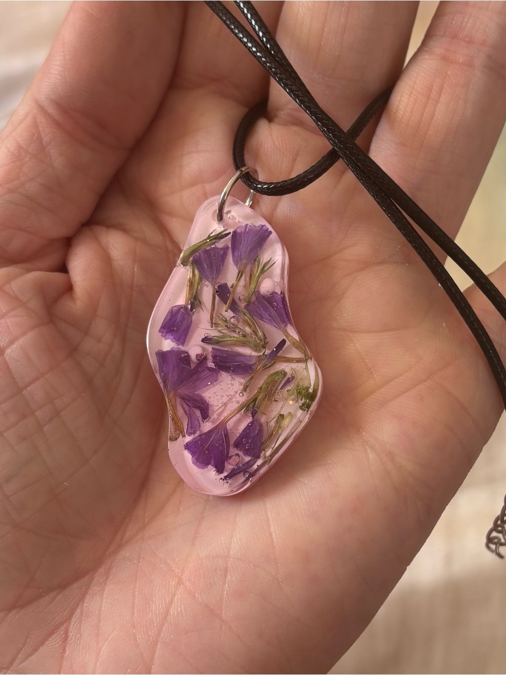 Handmade Pale Pink Resin Pendant with Purple Pressed Flowers on Black Cord